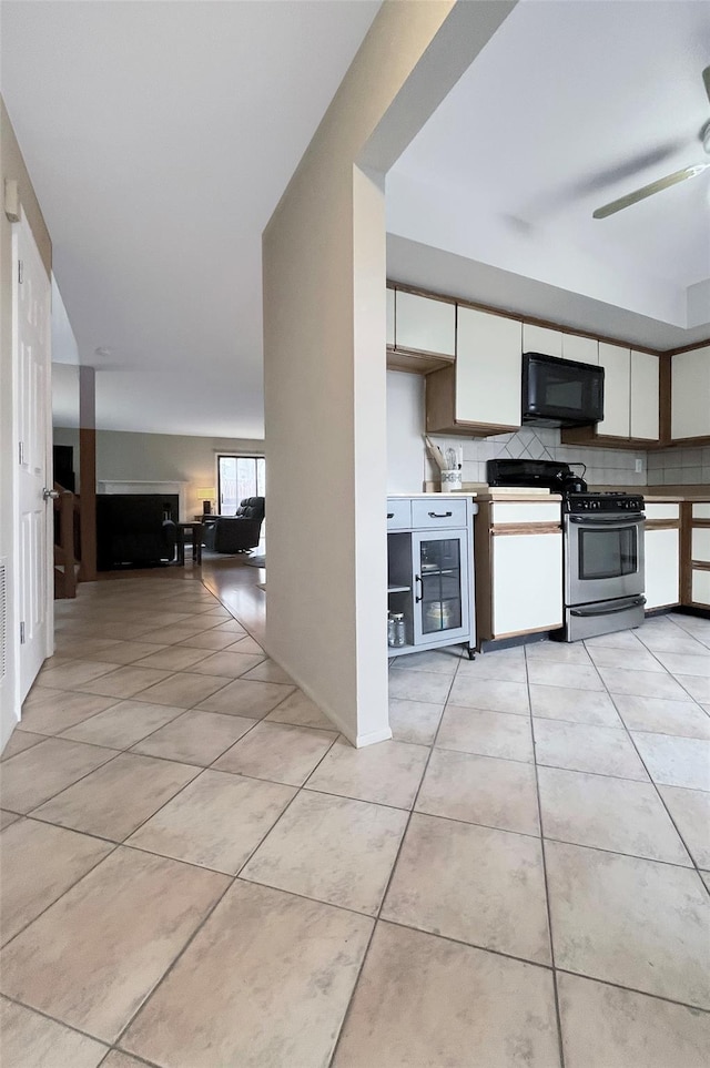 17 Cherry Ct, Highland Mills, NY 10930 - kitchen with ceiling fan, black microwave, white cabinetry, gas stove, and light tile patterned flooring
