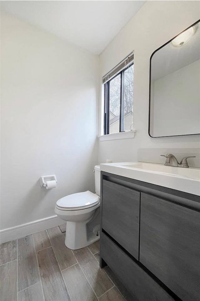 17 Cherry Ct, Highland Mills, NY 10930 - half bathroom featuring vanity, baseboards, wood finish floors, and toilet