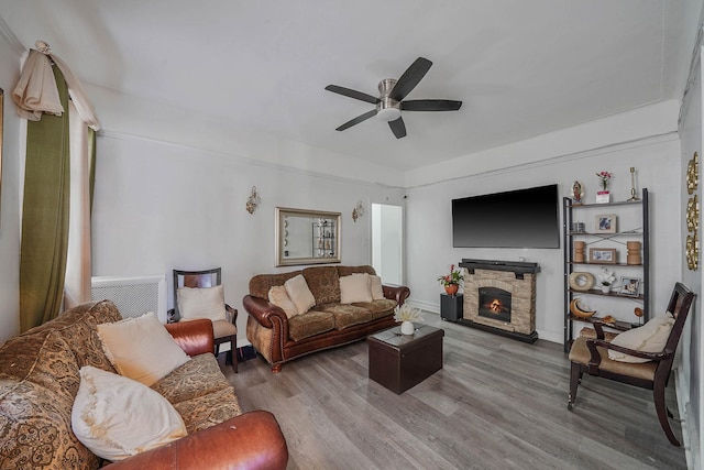 1754 Seward Ave, Bronx, NY 10473 - living room featuring baseboards, ceiling fan, wood finished floors, and a fireplace