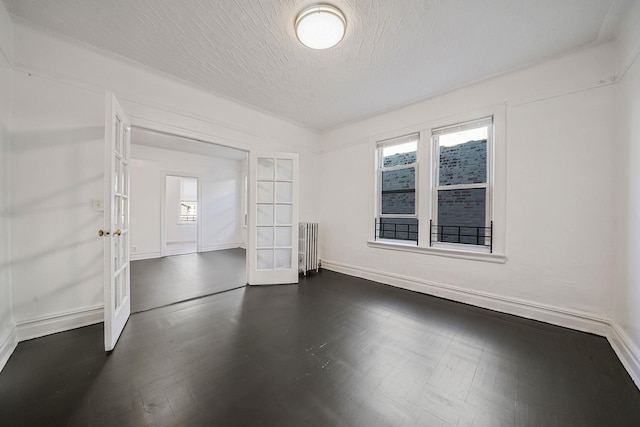 1754 Seward Ave, Bronx, NY 10473 - empty room with baseboards, french doors, and radiator