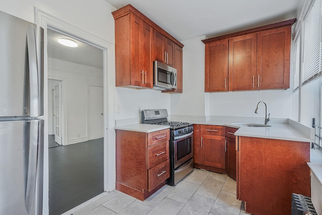 1754 Seward Ave, Bronx, NY 10473 - kitchen with appliances with stainless steel finishes, a sink, light tile patterned floors, light countertops, and radiator