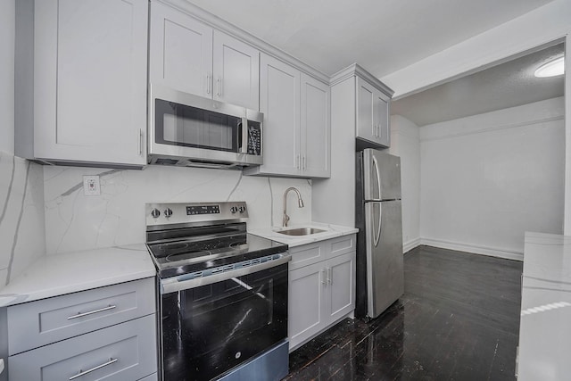 1754 Seward Ave, Bronx, NY 10473 - kitchen featuring dark wood-style flooring, gray cabinets, appliances with stainless steel finishes, and a sink
