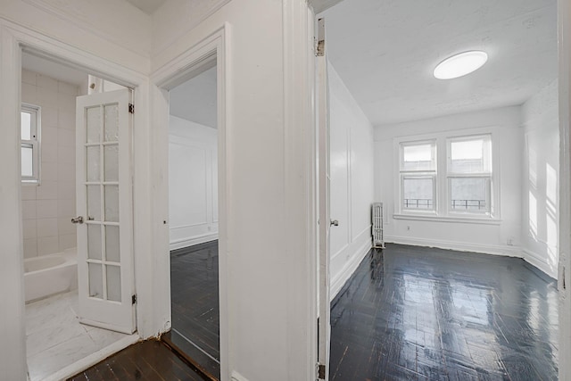 1754 Seward Ave, Bronx, NY 10473 - corridor featuring baseboards, dark wood finished floors, and radiator