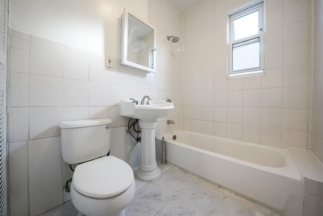 1754 Seward Ave, Bronx, NY 10473 - bathroom with tile walls, shower / bathtub combination, toilet, and marble finish floor