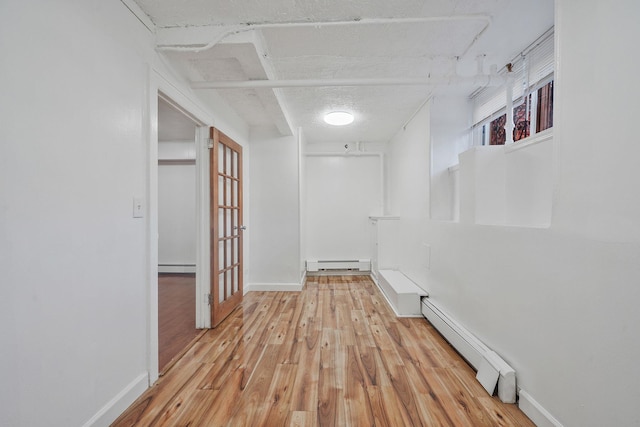 1754 Seward Ave, Bronx, NY 10473 - hallway with baseboards, baseboard heating, a baseboard heating unit, and wood finished floors