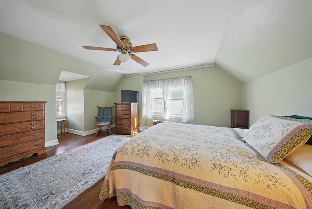 bedroom with multiple windows, wood finished floors, and lofted ceiling