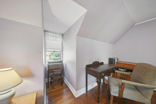 office space featuring baseboards, hardwood / wood-style flooring, and lofted ceiling