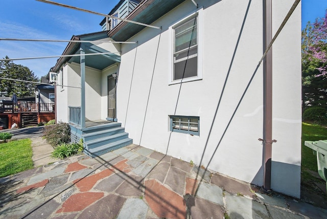doorway to property featuring stucco siding