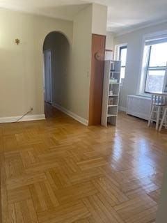 83-44 Lefferts Blvd Unit 6M, Kew Gardens, NY 11415 - unfurnished room with baseboards and arched walkways