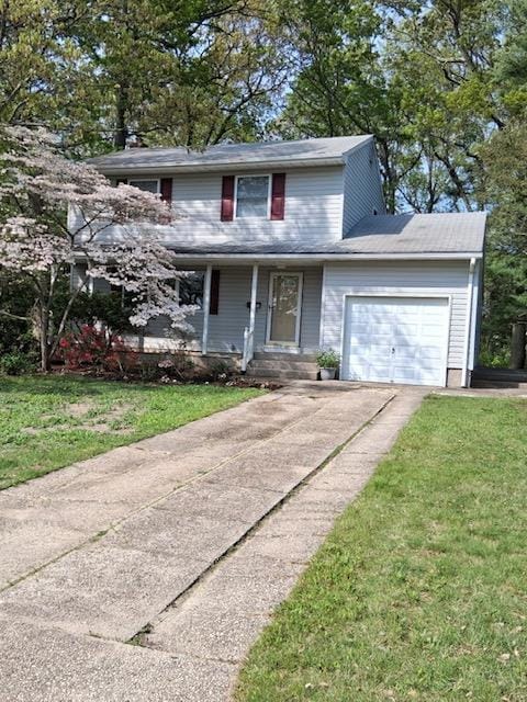 traditional home with an attached garage, driveway, and a front lawn