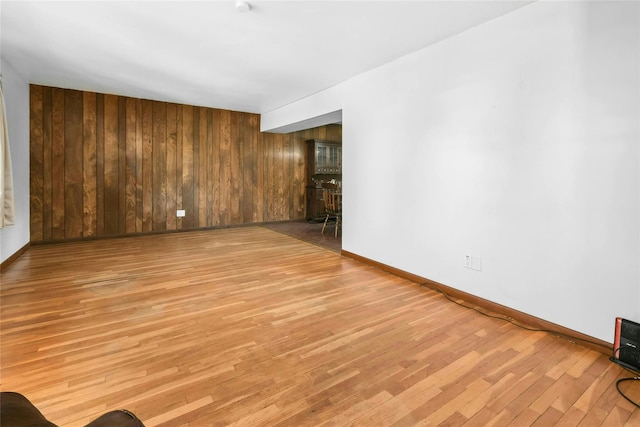 54 Schuyler Dr, Commack, NY 11725 - unfurnished room with light wood-style floors, wood walls, and baseboards