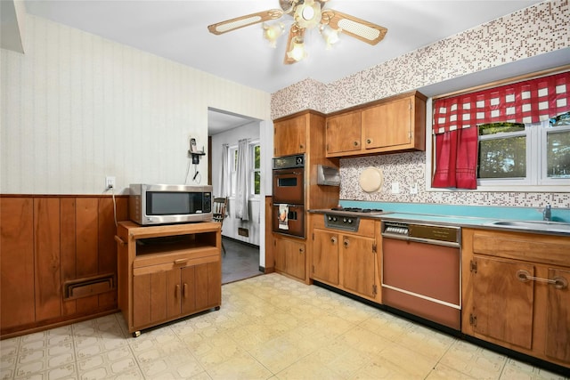 54 Schuyler Dr, Commack, NY 11725 - kitchen featuring stainless steel appliances, a sink, light floors, brown cabinetry, and ceiling fan