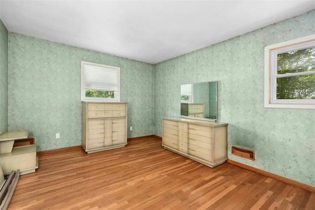54 Schuyler Dr, Commack, NY 11725 - unfurnished bedroom featuring light wood-type flooring, a baseboard heating unit, and baseboards