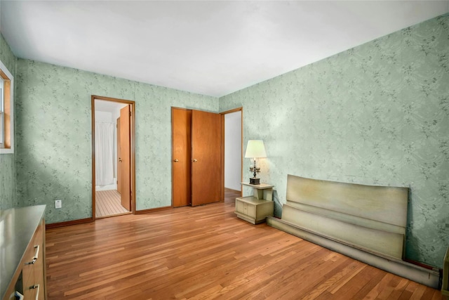 54 Schuyler Dr, Commack, NY 11725 - unfurnished room with wood finished floors and wallpapered walls