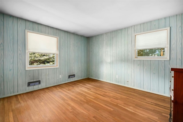 54 Schuyler Dr, Commack, NY 11725 - empty room with wood-type flooring, plenty of natural light, and baseboards