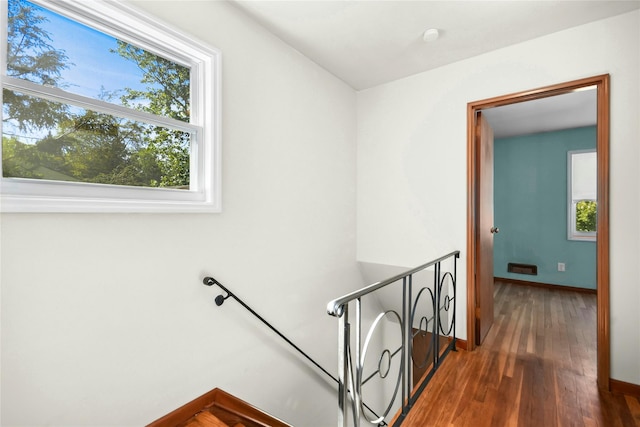 54 Schuyler Dr, Commack, NY 11725 - staircase with healthy amount of natural light, wood finished floors, and baseboards