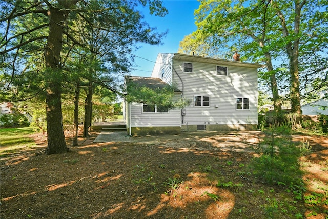 54 Schuyler Dr, Commack, NY 11725 - back of property with a chimney