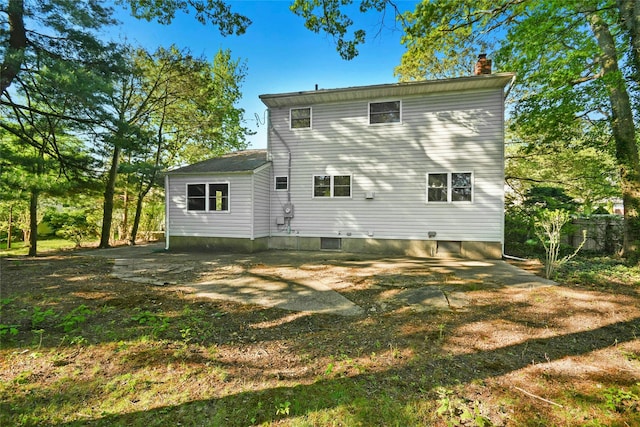 54 Schuyler Dr, Commack, NY 11725 - rear view of house with a chimney
