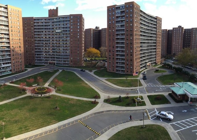 61-55 98th St Unit 8D, Rego Park, NY 11374 - view of building exterior featuring uncovered parking and a city view