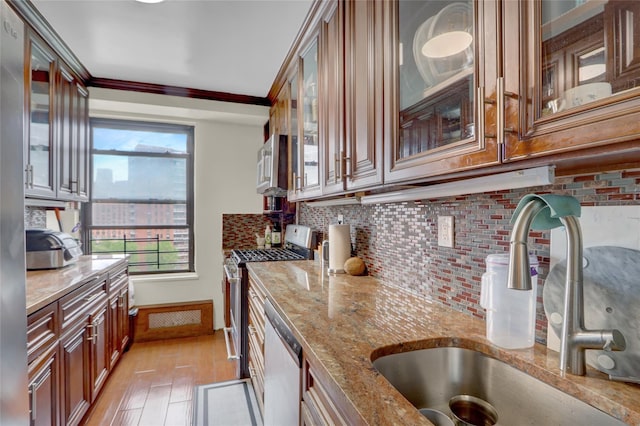 61-55 98th St Unit 8D, Rego Park, NY 11374 - kitchen featuring a sink, stainless steel appliances, light stone countertops, backsplash, and crown molding