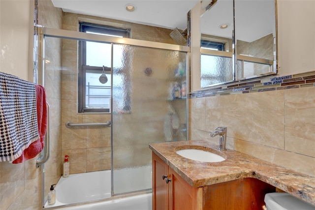 61-55 98th St Unit 8D, Rego Park, NY 11374 - full bath featuring shower / bath combination with glass door, vanity, toilet, backsplash, and tile walls