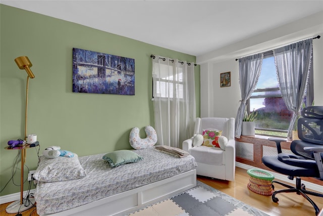 61-55 98th St Unit 8D, Rego Park, NY 11374 - bedroom featuring multiple windows and wood finished floors