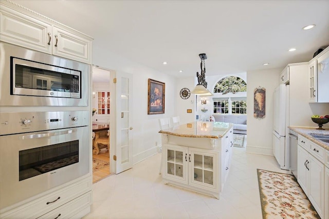 82 E Cedar St, Poughkeepsie, NY 12601 - kitchen with wall oven, stainless steel microwave, glass insert cabinets, freestanding refrigerator, and baseboards