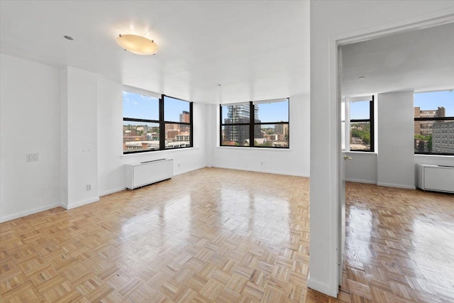 23 Water Grant St Unit 11C, Yonkers, NY 10701 - spare room featuring radiator, healthy amount of natural light, and baseboards