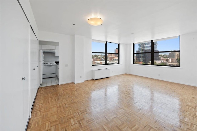 23 Water Grant St Unit 11C, Yonkers, NY 10701 - unfurnished living room with plenty of natural light and baseboards