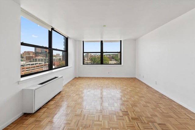 23 Water Grant St Unit 11C, Yonkers, NY 10701 - spare room with baseboards, radiator, and a city view