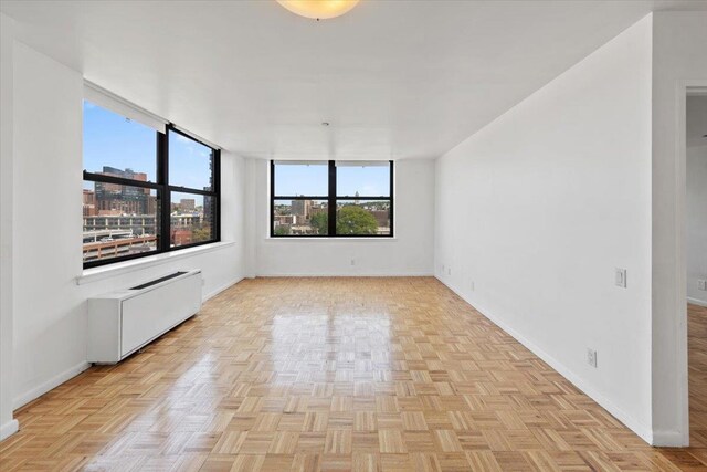 23 Water Grant St Unit 11C, Yonkers, NY 10701 - spare room featuring baseboards and radiator