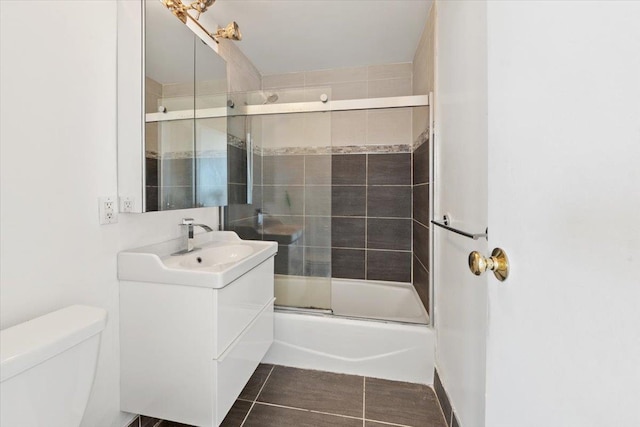 23 Water Grant St Unit 11C, Yonkers, NY 10701 - full bathroom featuring toilet, vanity, combined bath / shower with glass door, and tile patterned flooring