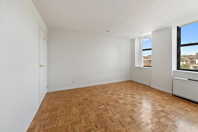 23 Water Grant St Unit 11C, Yonkers, NY 10701 - unfurnished room featuring plenty of natural light, radiator heating unit, and baseboards