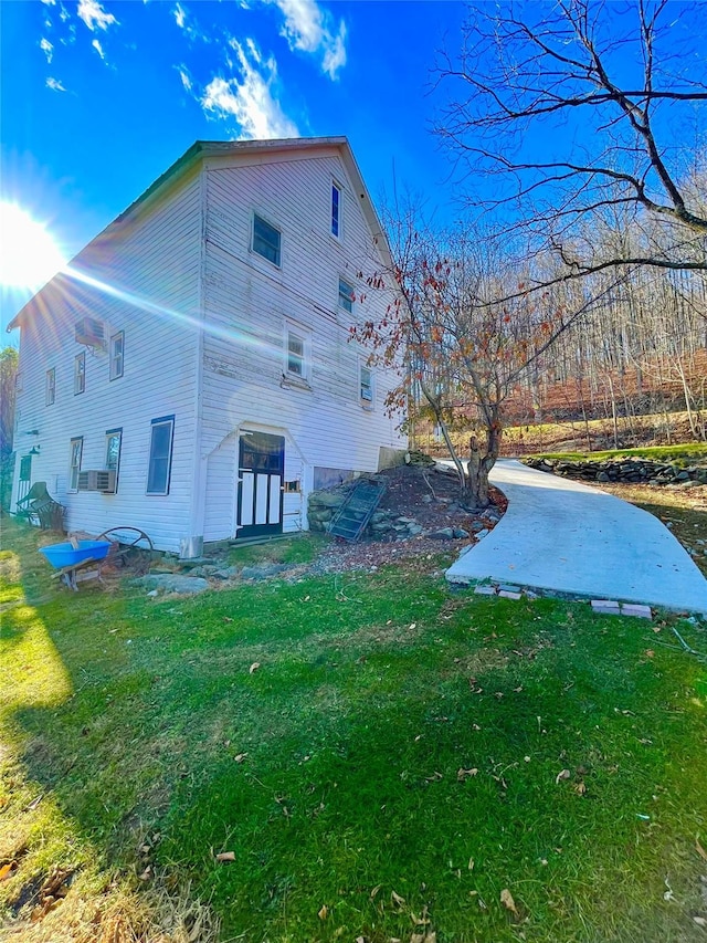 view of property exterior with a lawn