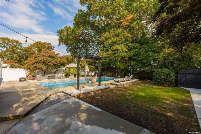 view of pool featuring a fenced backyard, a fenced in pool, a pergola, and a patio area