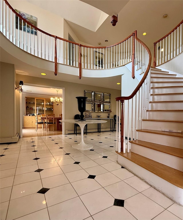 4 Pine Glen Dr, Blauvelt, NY 10913 - staircase with tile patterned flooring, a baseboard radiator, a notable chandelier, a high ceiling, and recessed lighting