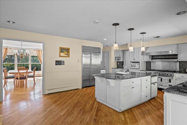 4 Pine Glen Dr, Blauvelt, NY 10913 - kitchen with high quality appliances, baseboard heating, light wood-type flooring, ventilation hood, and a notable chandelier