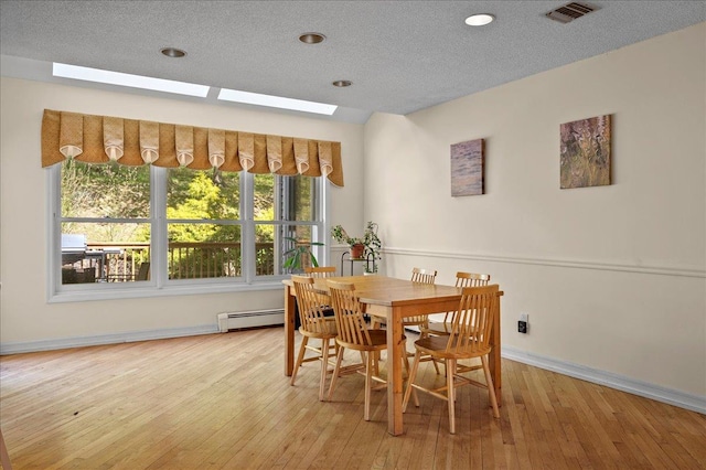 4 Pine Glen Dr, Blauvelt, NY 10913 - dining space featuring visible vents, a skylight, baseboards, a baseboard radiator, and wood-type flooring