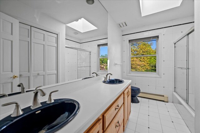 4 Pine Glen Dr, Blauvelt, NY 10913 - bathroom with a sink, a baseboard heating unit, toilet, and a skylight