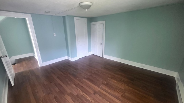 107 Garden St, Poughkeepsie, NY 12601 - unfurnished bedroom featuring a closet, baseboards, and dark wood-type flooring