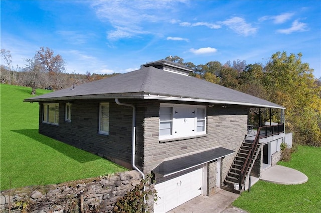view of property exterior featuring an attached garage, a yard, driveway, and stairway