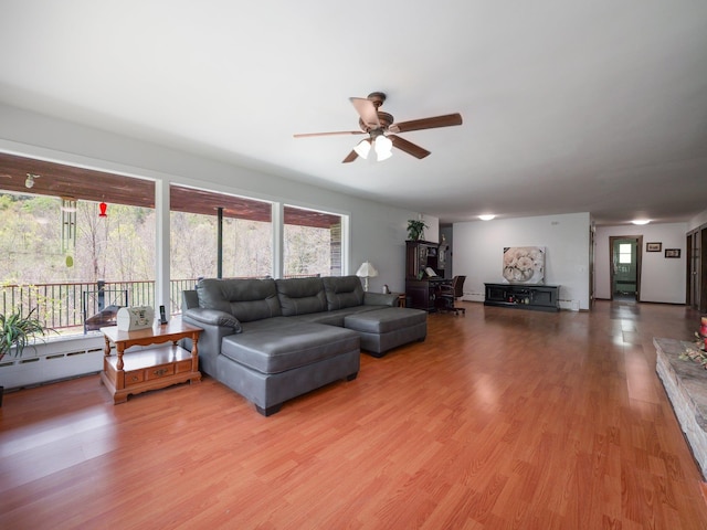 living room with a healthy amount of sunlight, ceiling fan, and light wood finished floors