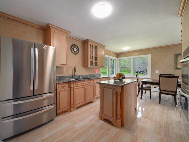 kitchen featuring appliances with stainless steel finishes, a center island, a sink, dark stone countertops, and glass insert cabinets