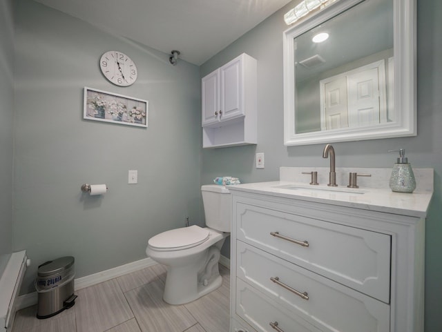 bathroom with baseboards, lofted ceiling, toilet, and vanity