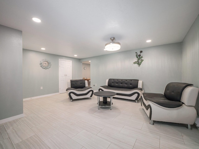 living area with baseboards and recessed lighting