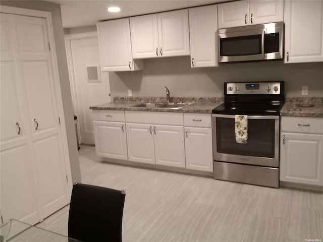6204 Rte 52, Ellenville, NY 12428 - kitchen featuring appliances with stainless steel finishes, a sink, white cabinets, and recessed lighting