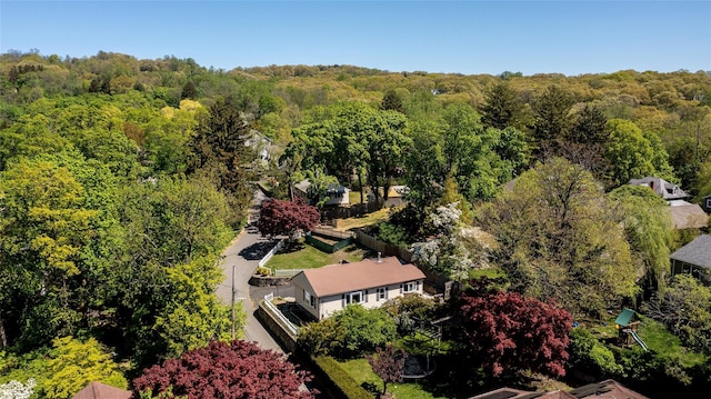 birds eye view of property with a forest view