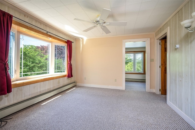 carpeted empty room featuring crown molding, baseboards, and baseboard heating
