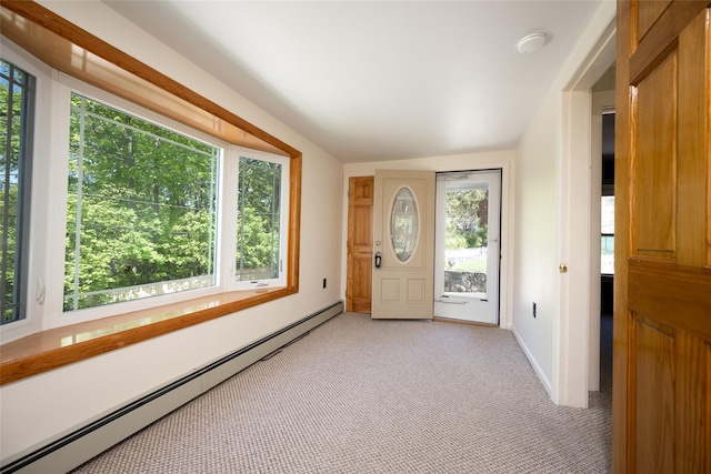 entrance foyer with baseboards, a wealth of natural light, baseboard heating, and light carpet