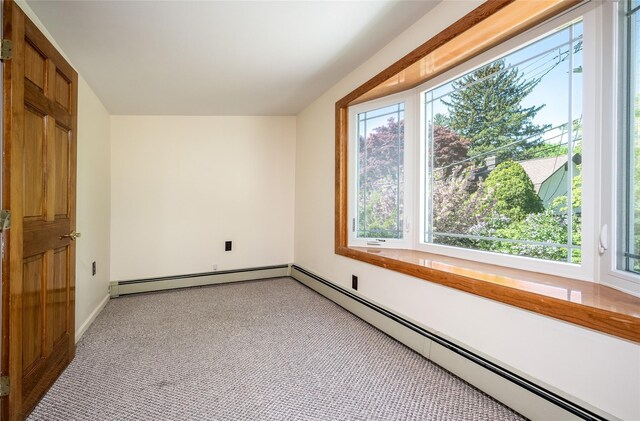 bonus room featuring baseboards, light carpet, and a baseboard heating unit